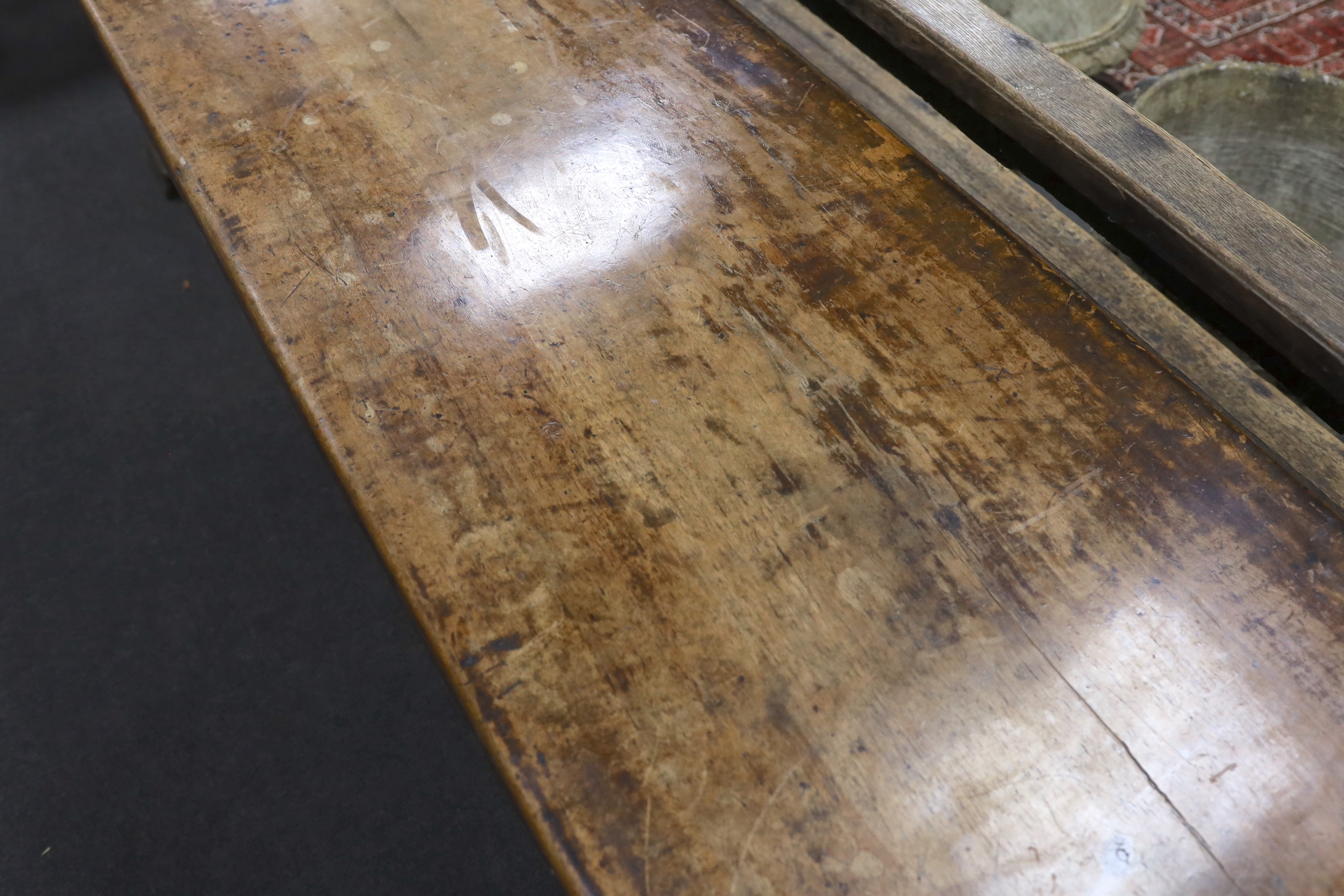 An 18th century style walnut refectory table, width 270cm, depth 59cm, height 74cm, Provenance- Brede Place, East Sussex, a former residence of the Frewen family from 1712-1936.